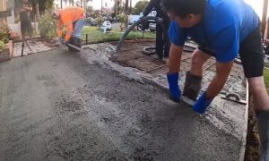 Barrie concrete paving workers adding concrete on a driveway